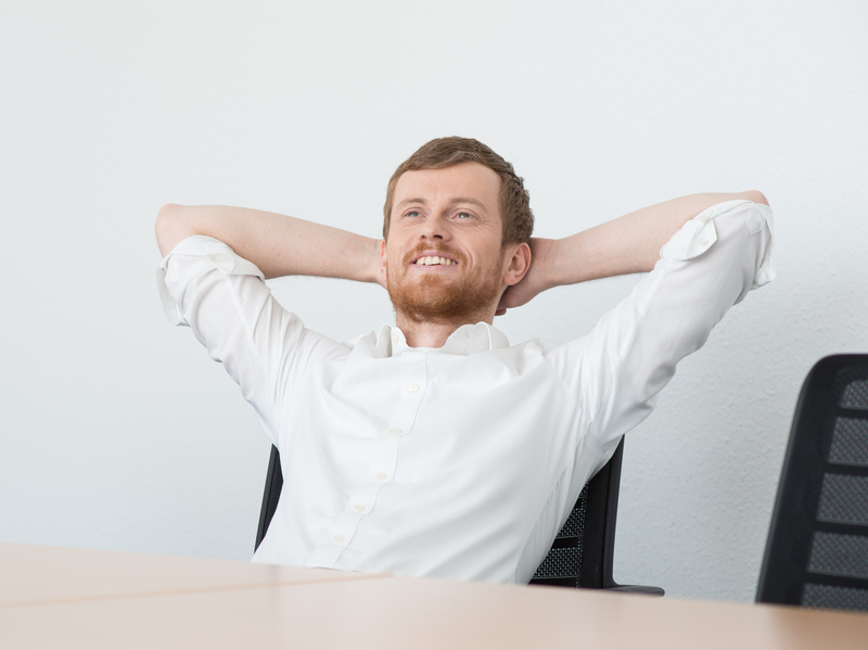 Ein entspannter Mann sitzt an einem Tisch, umgeben von Wasserflaschen in einem Büro. SHD optimiert Arbeitsumgebungen für effiziente IT-Lösungen.