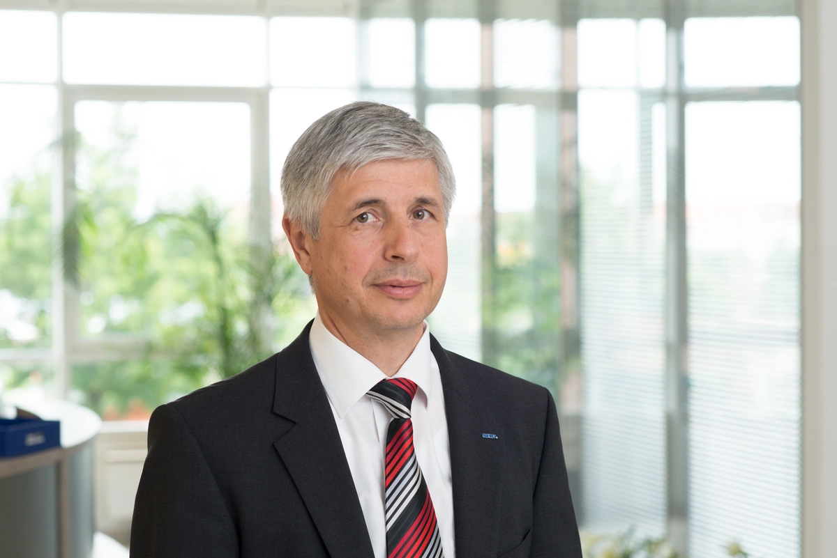 Ehemaliger SHD Geschäftsführer im Portrait vor einer Fensterfront im Dresdner Büro